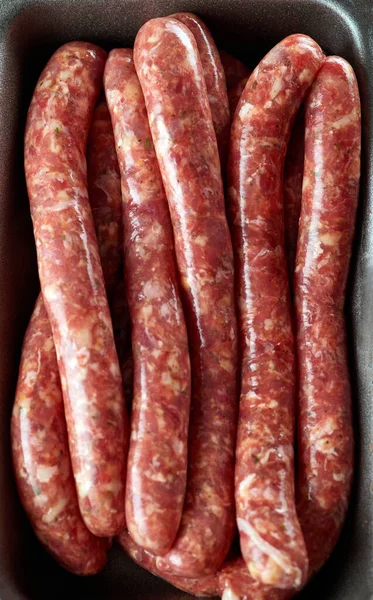 Raw Beef bratwurst. German sausages. Rinderbratwurst. Fresh raw beef sausages. Close up.