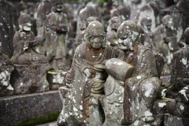 Ancient stone statues of Rakan at Kita-in Temple in Kawagoe, Saitama, Japan. Each statue shows a different character and expression.