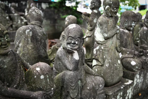 Ancient stone statues of Rakan at Kita-in Temple in Kawagoe, Saitama, Japan. Each statue shows a different character and expression.