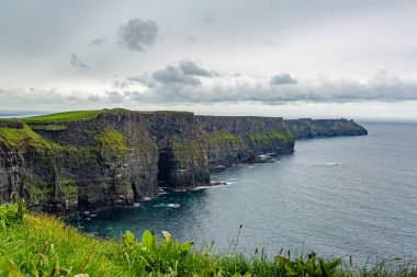 Irish landscape of the Cliffs of Moher, geosites and geopark, Wild Atlantic Way, wonderful cloudy spring day in the countryside in County Clare in Ireland