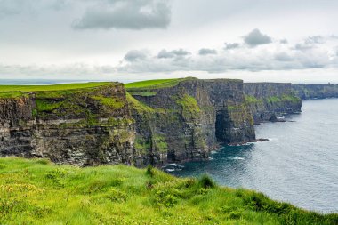 Beautiful Irish landscape of the Cliffs of Moher, geosites and geopark, Wild Atlantic Way, wonderful cloudy spring day in the countryside in county Clare in Ireland