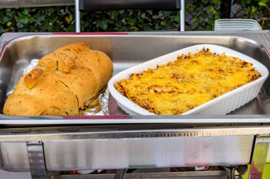 Aztec cake or pastel Azteca, Mexican food and ham bread, Venezuela food on a chafing dish, delicious combination of flavor and texture in a Latin American buffet