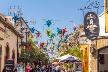 Pinatas suspended on a street in Tlaquepaque, beautiful traditions of Mexican culture, wonderful sunny day in Jalisco, Mexico