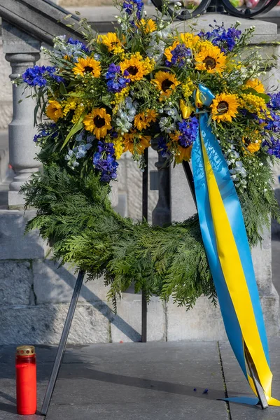Wreath of flowers in the protest against the Russian armed invasion of Ukraine. Protesting peacefully. Concept of pacifism and prayer for peace in the world. Roermond in Limburg, Netherlands