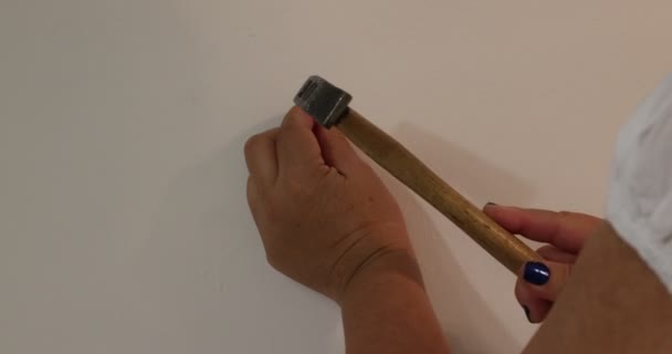 Adult Female Hands Holding Nail Her Fingers Drive White Wall — Video Stock