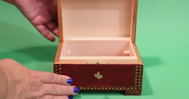 Female Hands Opening Finely Carved Wooden Box Putting 200 100 — Stockvideo