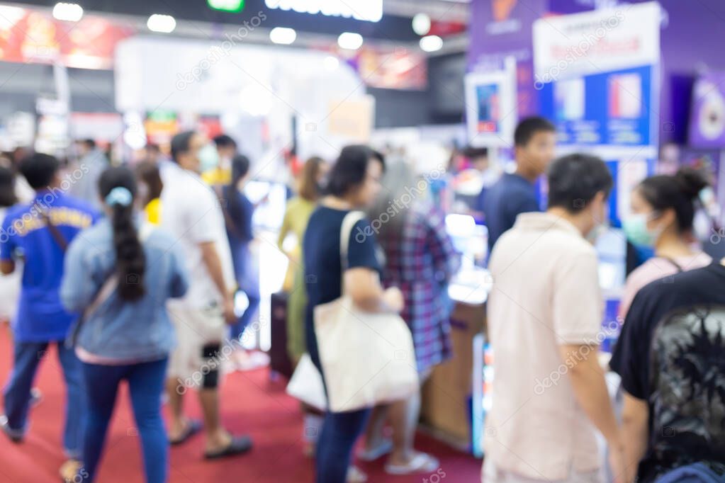 Abstract blur people in exhibition hall event trade show expo background. Business convention show, job fair, or stock market.