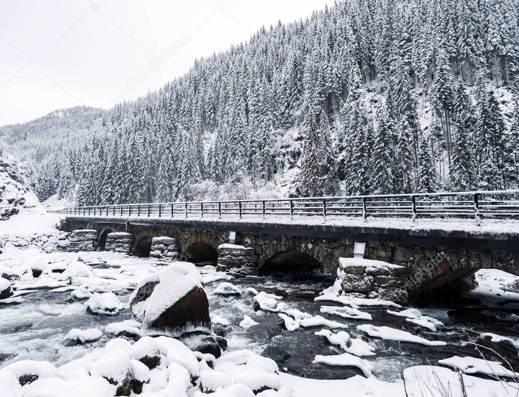 River Grnsdalslona near Latefossen Waterfall during cold winter in Odda