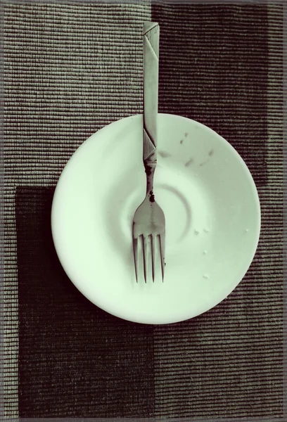 A small plate and fork — Stock Photo, Image