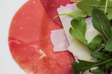 Taze kesilmiş et ve salata. Parmesan peynirli ve roka soslu Carpaccio..