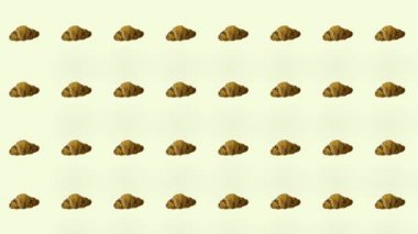 Ay çöreğinin renkli deseni. Kruvasanla kusursuz bir desen. Üst Manzara. Gerçekçi animasyon. 4K video hareketi