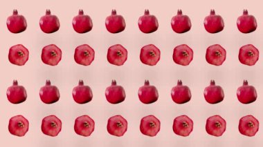 Pembe arka planda taze kırmızı nar renginde meyveler. Nar ile kusursuz desen. Gerçekçi animasyon. 4K video hareketi