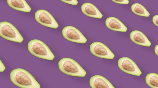 Colorful fruit pattern of fresh avocados on purple background. Seamless pattern with avocado. Realistic animation. 4K video motion — Stockvideo