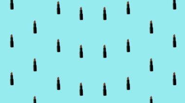 Mavi arka planda renkli ruj deseni. Rujla kusursuz desen. Üst Manzara. Gerçekçi animasyon. 4K video hareketi