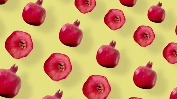 Colorful fruit pattern of fresh red pomegranates on yellow background with shadows. Seamless pattern with pomegranate. Realistic animation. 4K video motion — Stockvideo