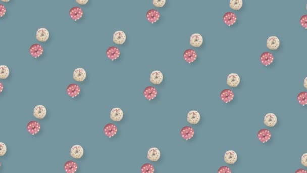 Colorful pattern of rotating donuts isolated on grey background. Seamless pattern with donut. Doughnuts. Top view. Realistic animation. 4K video motion — Vídeo de Stock