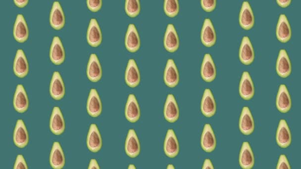 Colorful fruit pattern of fresh avocados on green background. Seamless pattern with avocado. Realistic animation. 4K video motion — Stockvideo