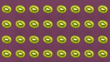 Renkli kivi deseni. Üst Manzara. Minimum tropikal meyve konsepti. Kivi dilimlenmiş kusursuz desen. Pop sanat tasarımı. Gerçekçi animasyon. 4K video hareketi