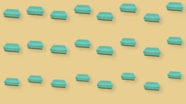 Turuncu arka planda yeşil mutfak süngeri deseni. Süngerle kusursuz desen. Üst Manzara. Gerçekçi animasyon. 4K video hareketi