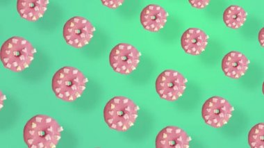 Yeşil arka planda izole edilmiş, gölgeli pembe çörek deseni. Donutla kusursuz desen. Çörekler. Üst Manzara. Gerçekçi animasyon. 4K video hareketi