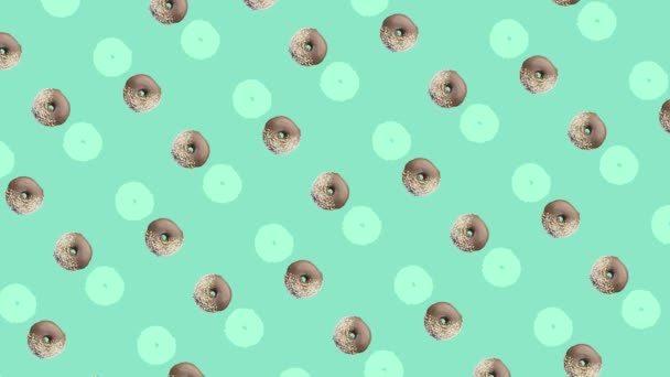 Colorful pattern of donuts isolated on green background. Seamless pattern with donut. Doughnuts. Top view. Realistic animation. 4K video motion — Stock Video