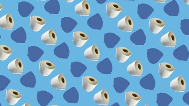 Colorful pattern of rolls of a white toilet paper isolated on blue background. Seamless pattern with toilet paper. Top view. Realistic animation. 4K video motion — Stockvideo