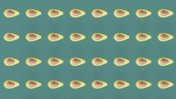 Modèle de fruits colorés d'avocats frais sur fond vert. Motif sans couture avec avocat. Animation réaliste. Mouvement vidéo 4K — Video