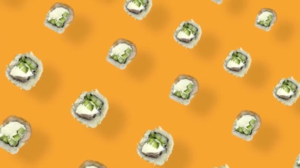 Colorful pattern of japanese sushi rolls on orange background with shadows. Seamless pattern with sushi. Top view. Realistic animation. 4K video motion — Video Stock