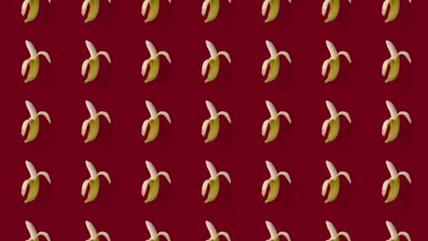 Colorful fruit pattern of fresh yellow bananas on red background. Seamless pattern with banana. Realistic animation. 4K video motion — Stock Video