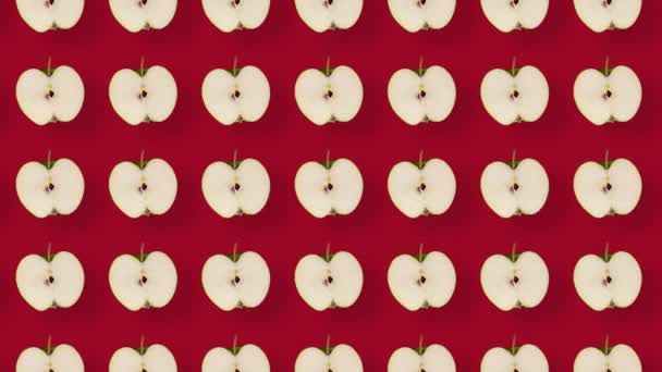 Barevný ovocný vzor čerstvých jablek na červeném pozadí se stíny. Bezešvý vzor s nakrájeným jablkem. Realistická animace. Pohyb videa 4K — Stock video