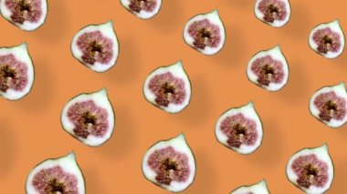 Turuncu arka planda gölgeli taze incir renkli meyve deseni. İncir dilimlenmiş kusursuz desen. Gerçekçi animasyon. 4K video hareketi