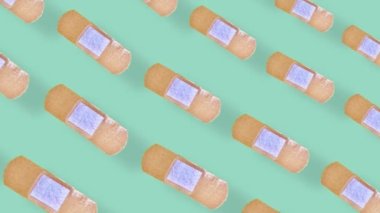 Yeşil arka planda gölgeli yapışkan alçı desenleri. Alçıyla kusursuz desen. Üst Manzara. Gerçekçi animasyon. 4K video hareketi