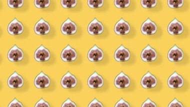 Turuncu arka planda gölgeli taze incir renkli meyve deseni. İncir dilimlenmiş kusursuz desen. Gerçekçi animasyon. 4K video hareketi