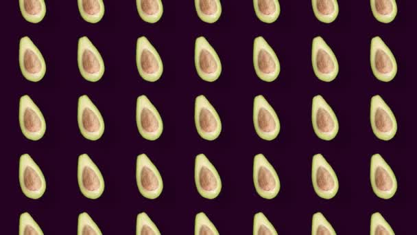 Patrón colorido de aguacates frescos. Vista superior. Concepto mínimo de frutas tropicales. Patrón sin costuras con aguacate en rodajas. Diseño de arte pop. Animación realista. Movimiento de vídeo 4K — Vídeo de stock