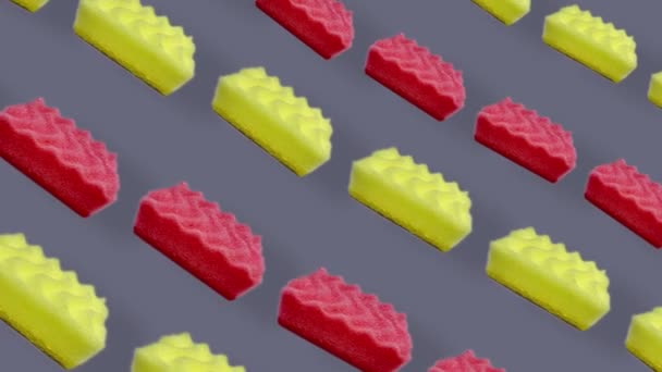 Kleurrijk patroon van roze en gele keukensponzen. Naadloos patroon met spons. Bovenaanzicht. Realistische animatie. 4K video beweging — Stockvideo