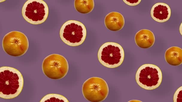 Colorful pattern of fresh grapefruits. Top view. Seamless pattern with grapefruit sliced. Pop art design. Realistic animation. 4K video motion — Vídeo de Stock