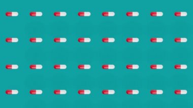 Yeşil arka planda renkli haplar. Kapsüllü kusursuz desen. Tıbbi, eczane ve sağlık hizmetleri konsepti. - Yakın çekim. 4K video hareketi