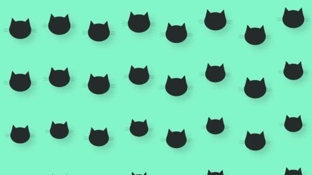 緑の背景に黒猫の頭のカラフルなパターン。猫の顔をしたシームレスなパターン。最上階だ。動物のシルエット。4Kビデオモーション — ストック動画
