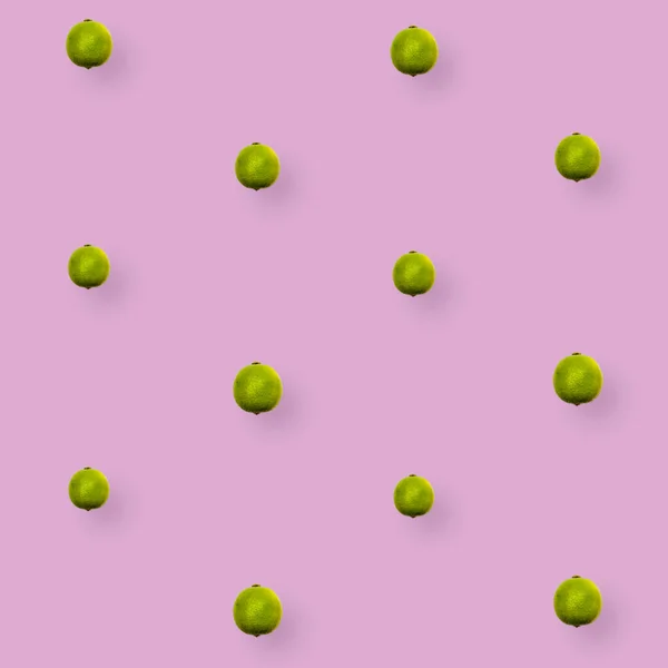 Colorful fruit pattern of fresh limes on pink background. Top view. Flat lay. Pop art design — Stock Photo, Image