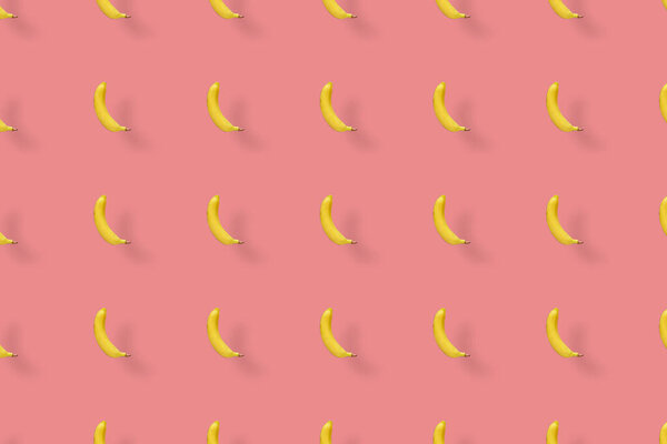 Colorful fruit pattern of yellow bananas on pink background. Top view. Flat lay. Pop art design