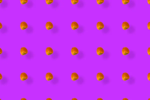 Colorful fruit pattern of fresh persimmons on purple background. Top view. Flat lay. Pop art design — Stock Photo, Image