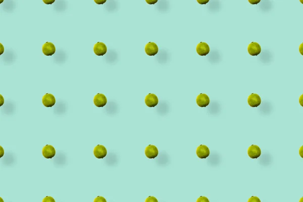 Barevný ovocný vzor čerstvých limetek na zeleném pozadí se stíny. Horní pohled. Ležel. Pop art design — Stock fotografie