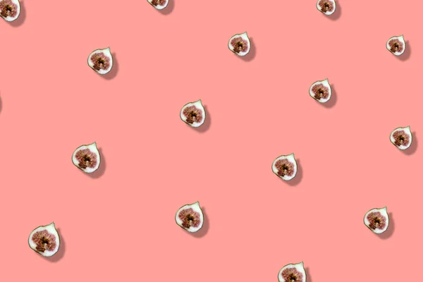 Barevný ovocný vzor čerstvých fíků krájených na růžovém pozadí se stíny. Horní pohled. Ležel. Pop art design — Stock fotografie