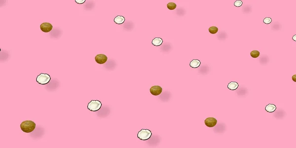 Kolorowy wzór orzechów kokosowych na różowym tle z cieniami. Widok góry. Leżeć płasko. Projektowanie pop art — Zdjęcie stockowe