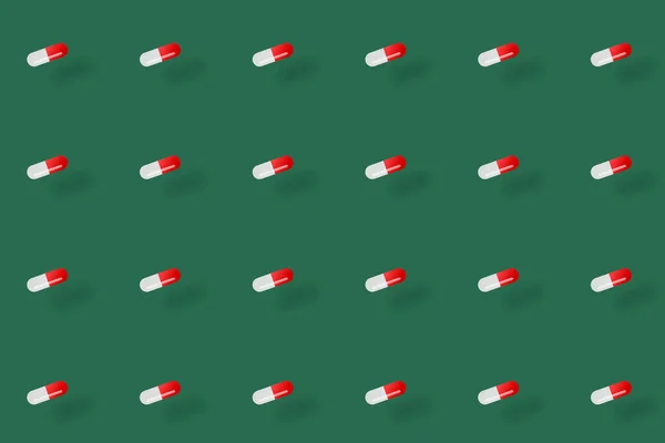 Patrón colorido de píldoras sobre fondo verde con sombras. Patrón sin costuras con cápsulas. Concepto médico, farmacéutico y sanitario —  Fotos de Stock