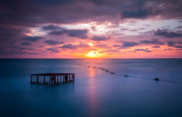Seascape and Empty Cage at Colorful Sunset — Stock Photo, Image