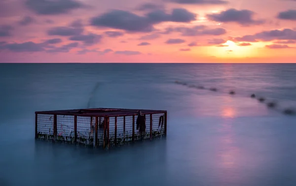 Seascape and Empty Cage at Colorful Sunset — Stock Photo, Image