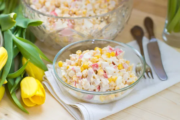 Crabmeat, rice and corn salad with mayonnaise sauce and yellow tulips — Stock Image Crabmeat, rice and corn salad with mayonnaise sauce and yellow tulips Stock Image