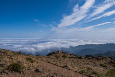 PICO DO ARIEIRO, MADEIRA - Ekim 2021: Güneşli bir sonbahar gününde Pico do Areeiro 'dan Pico Ruivo' ya Madeira dağlarında yürüyüş yapan bir grup turist