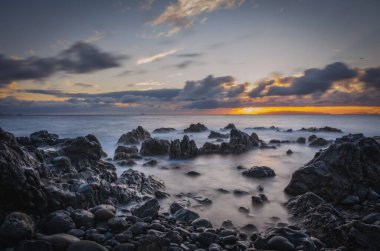 Reis Magos sahilinde gün doğumu. Canico, Madeira, Portekiz. Ekim 2021. Uzun pozlama resmi